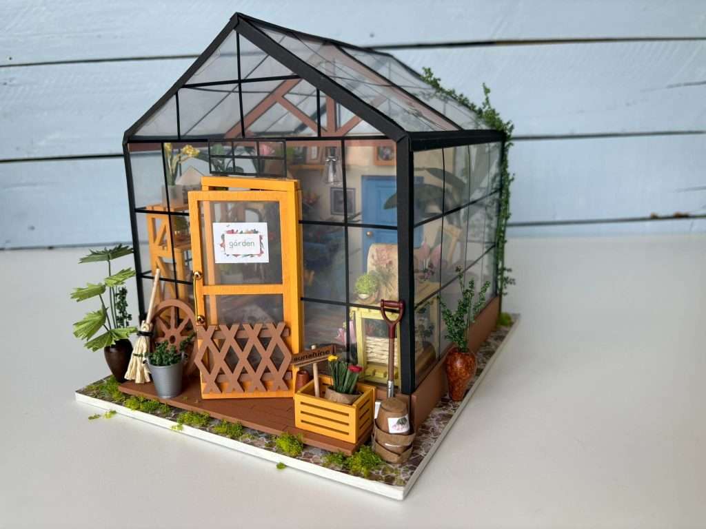 miniature greenhouse built from a craft kit
