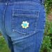 jeans rear pocket decorated with button flower yellow