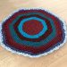 crochet round rug on wooden floor