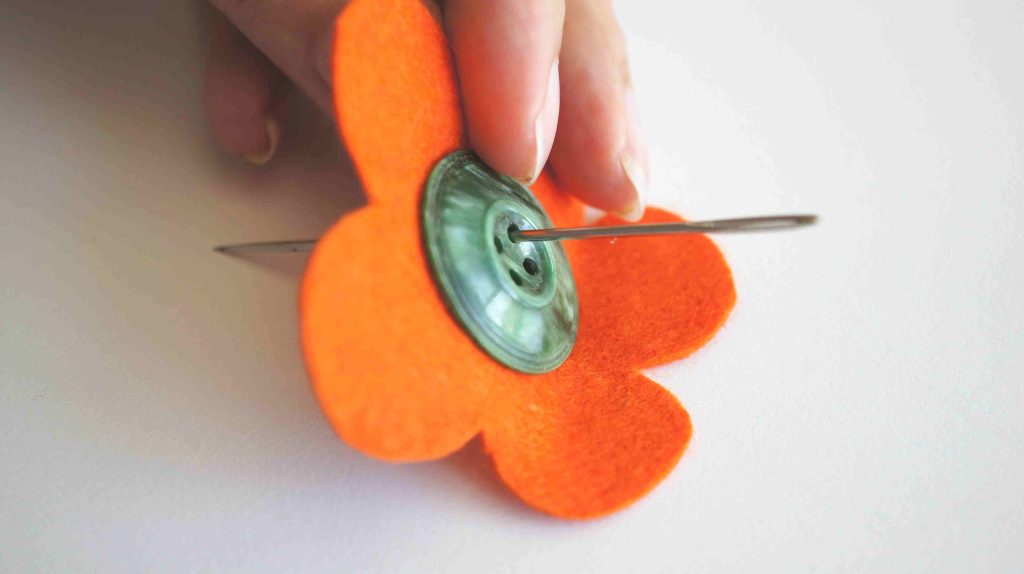 felt and button flower with needle through