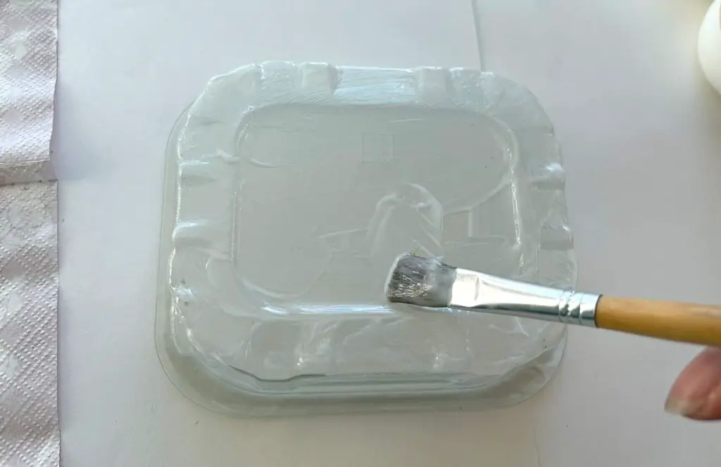 applying glue onto container base