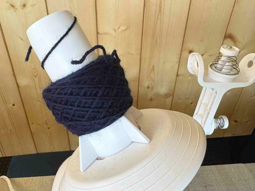 completed yarn cake on electric yarn winder