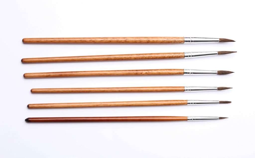paintbrushes flat on table drying