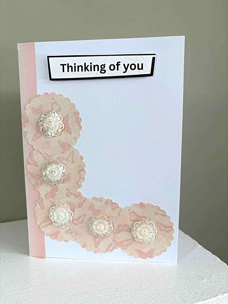 greeting card made using pretty paper and buttons to form flowers
