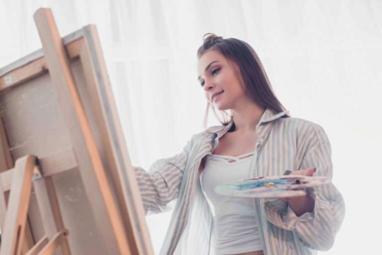 woman painting on canvas