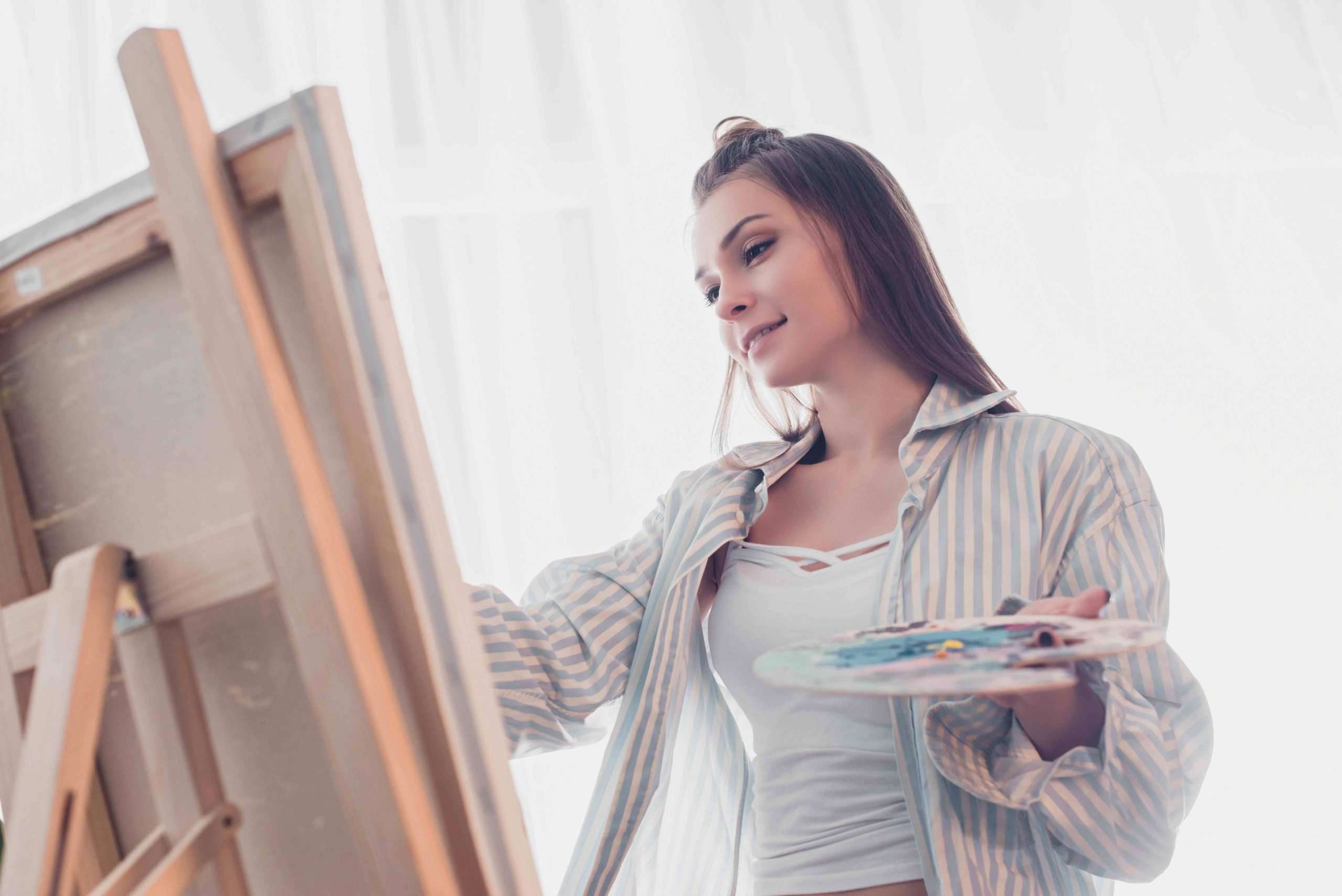 woman painting on canvas