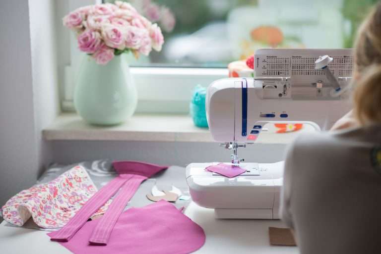woman at sewing machine with flowers