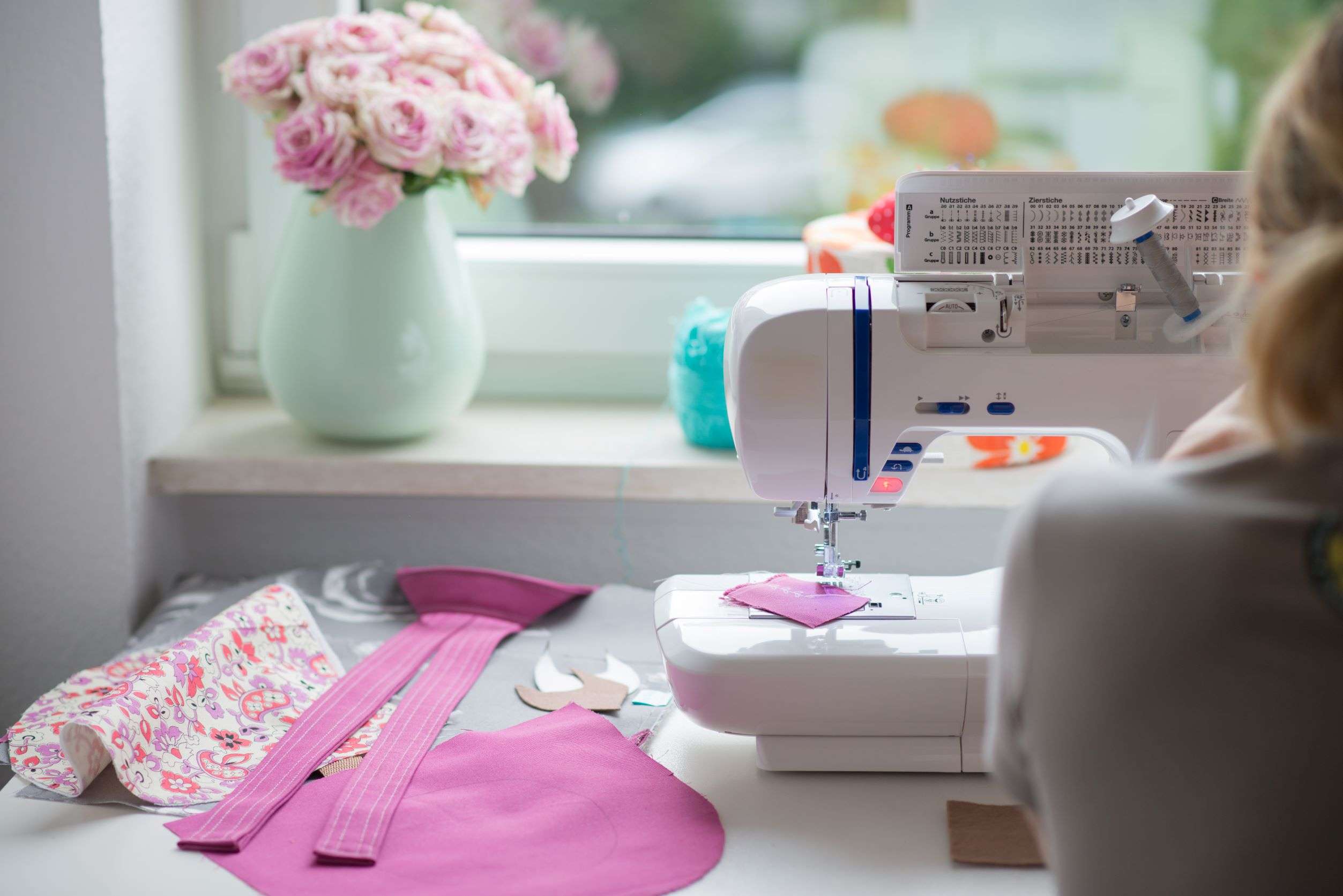 woman at sewing machine with flowers