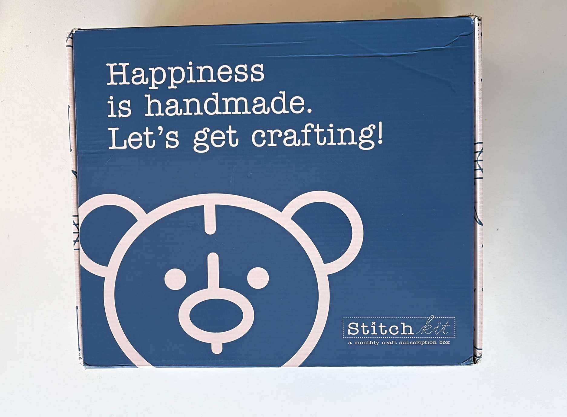 blue stitch kit box with cute bear image on it