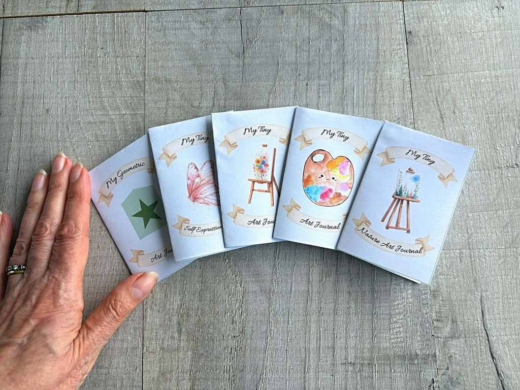 5 journals and hand