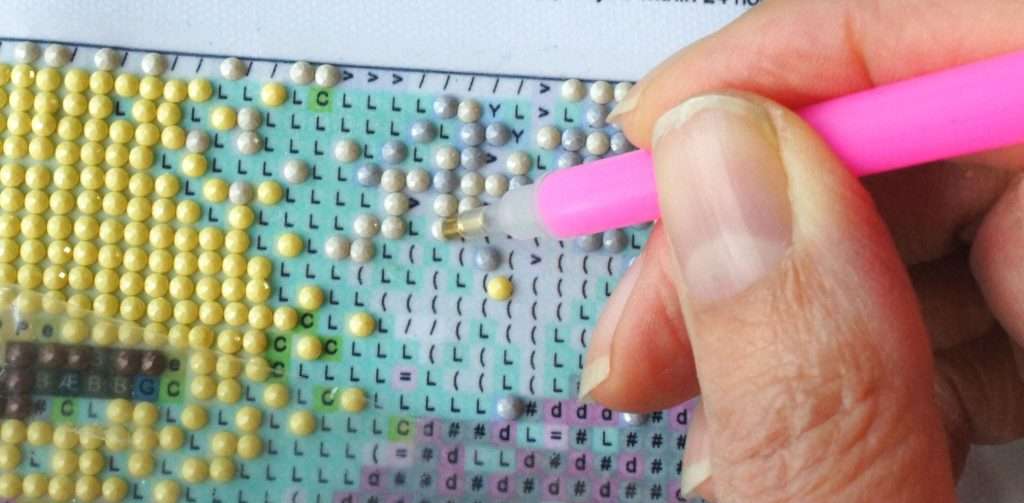 someone doing diamond painting