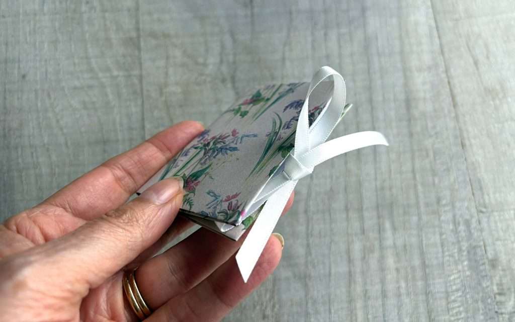 miniature notebook fastened with a ribbon