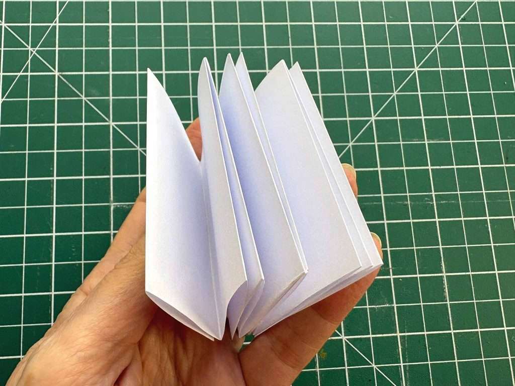 notebook pages folded in hand