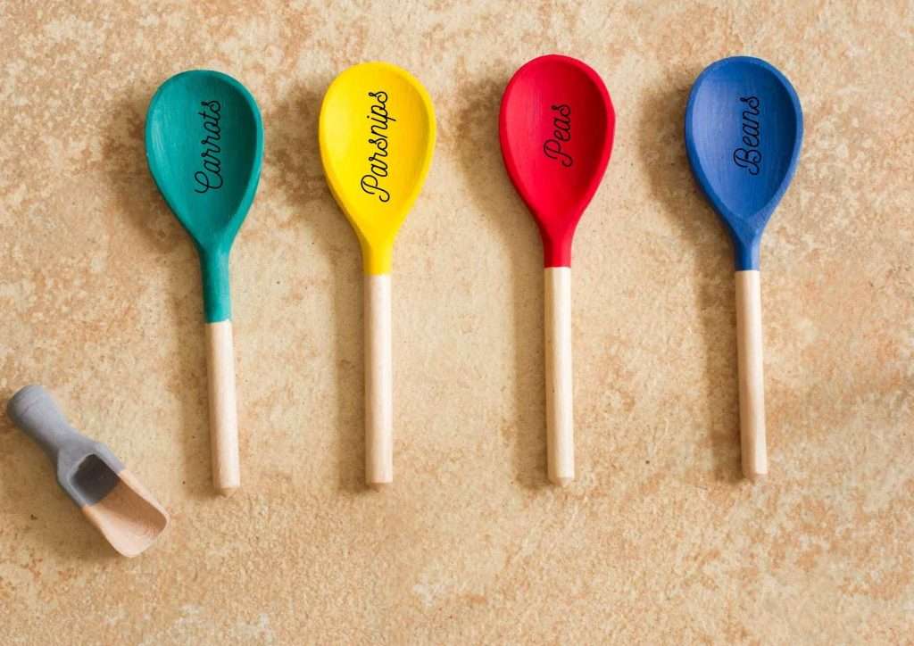 brightly coloured wooden spoon garden markers