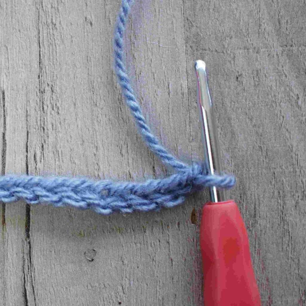 chain stitch in blue with pink crochet hook