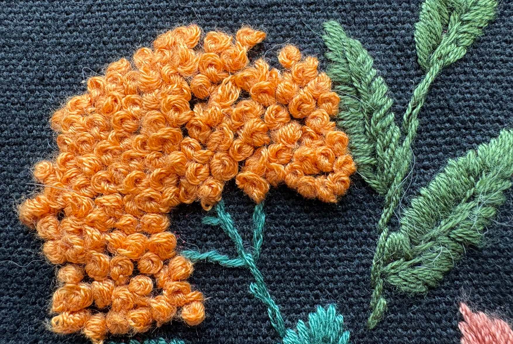 yellow french knot flowers in a design on a black background