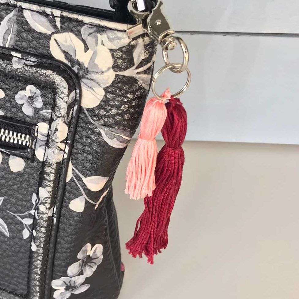 pink and red tassels on a bag as a charm 