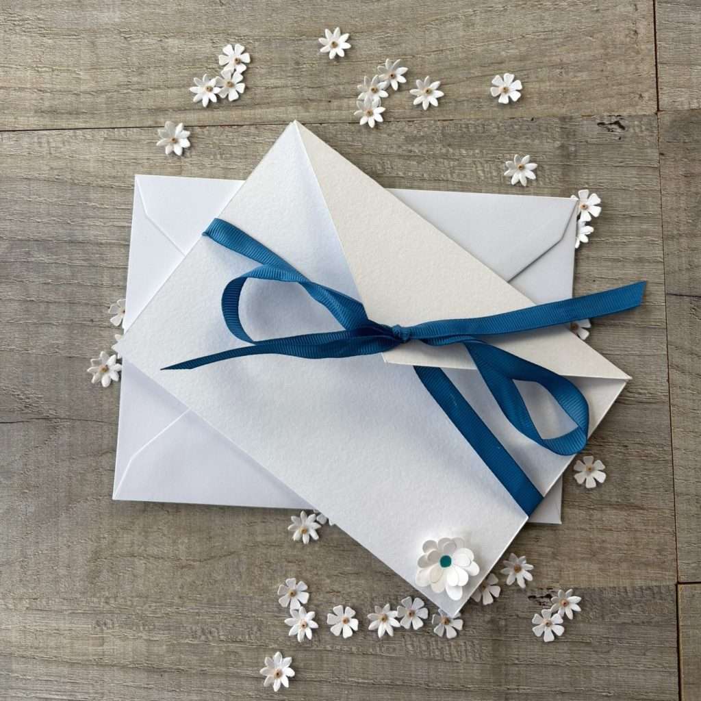 DIY wedding invitation with blue ribbon closure