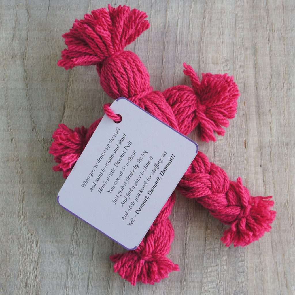 pink yarn doll with poem attached