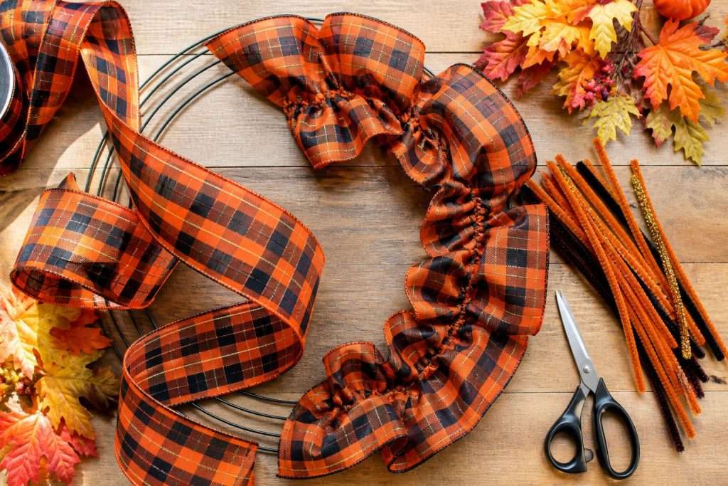 black and orange wreath being made