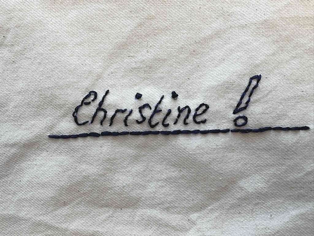 back stitch lettering spelling out Christine in blue thread