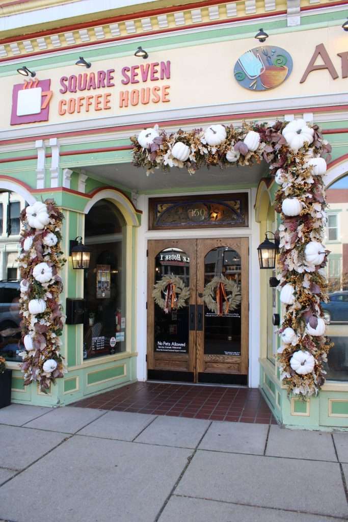 A festive front door with white pumpkins.