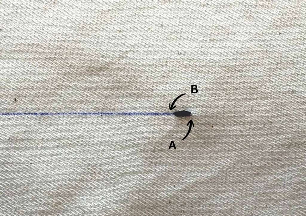 one blue stitch on a beige fabric