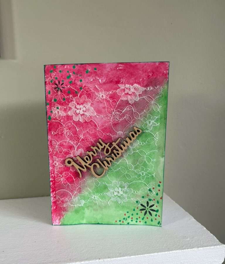 red and green Christmas card on a mantelpiece