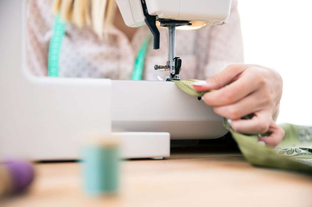 woman using a sewing machine close-up
