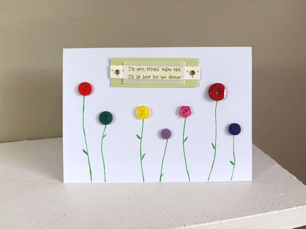 button flower card on mantelpiece