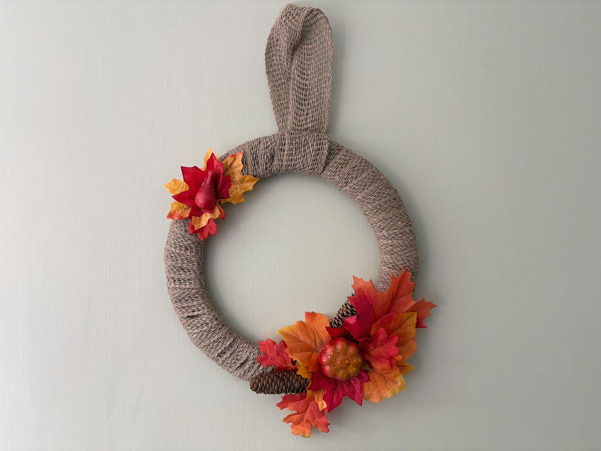 burlap autumn wreath with orange and red leaves