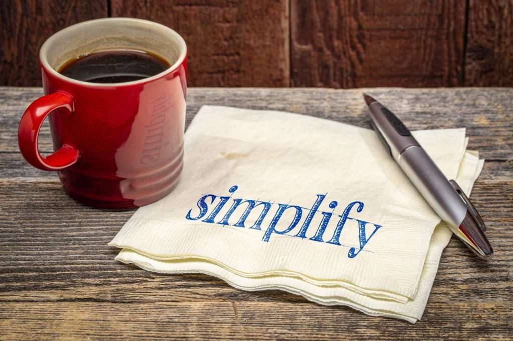 simplify on a napkin with a mug and pen