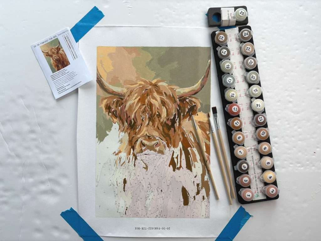 Paint a Moment Highland Cow painting part completed with paints