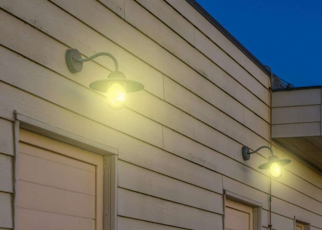 2 lit outdoor lights on a house